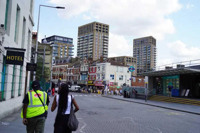Walking through town, towers behind
